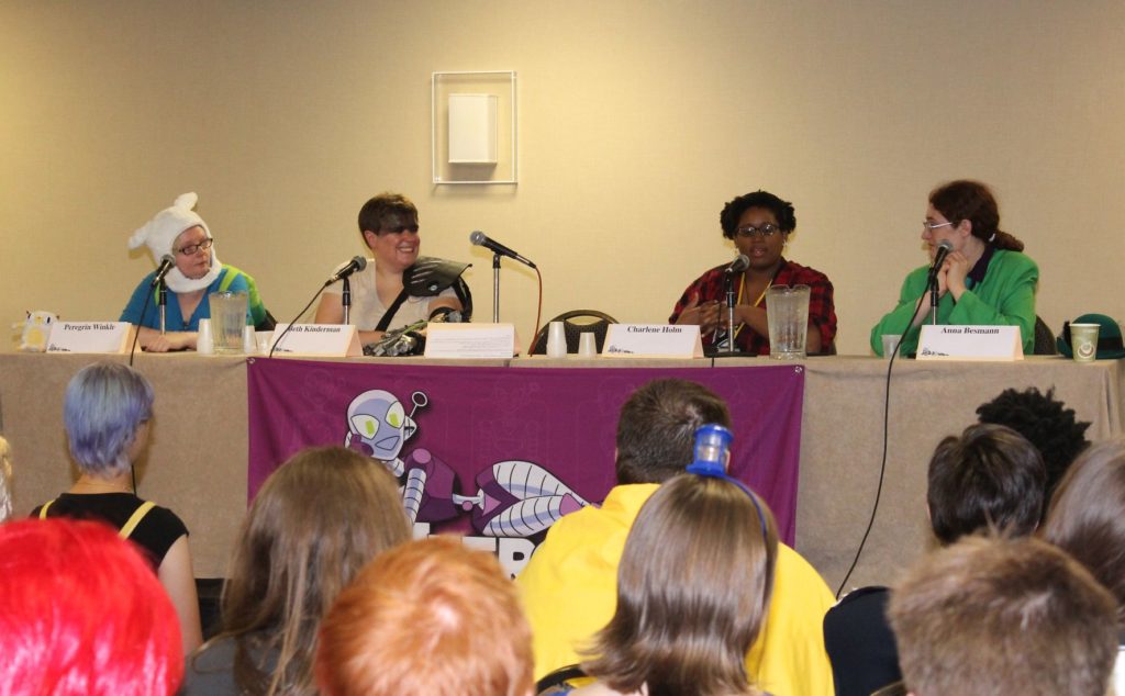 4 panelists sitting at a table with a CONvergence banner across it