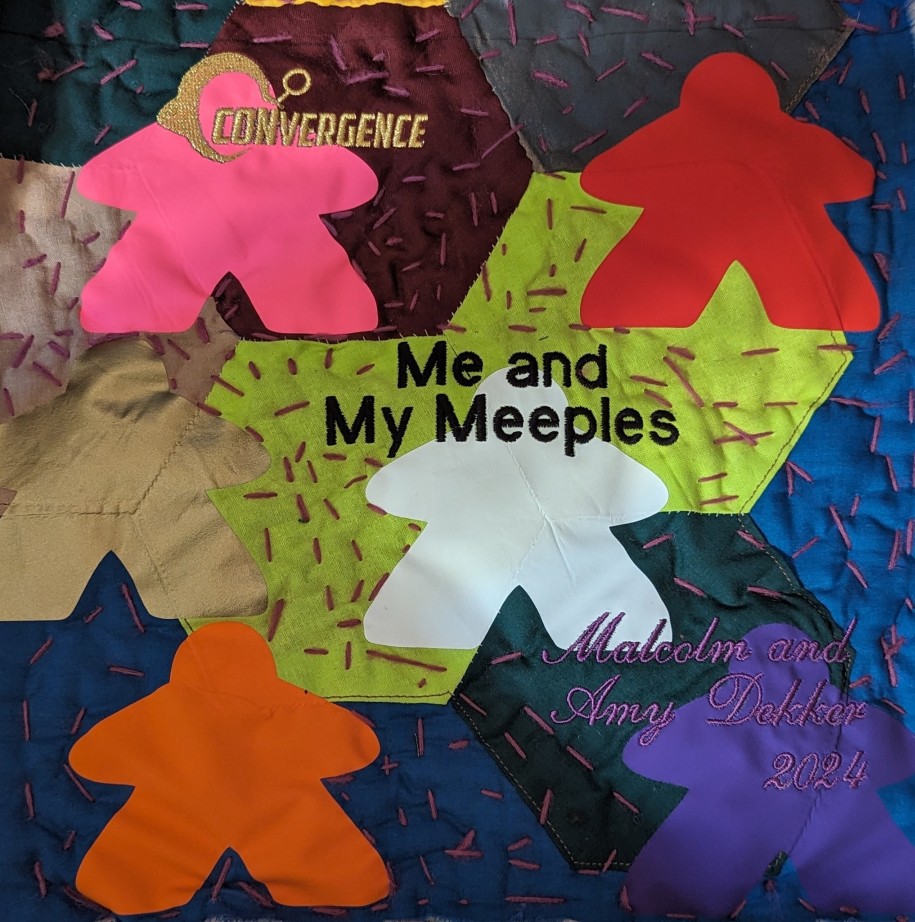 Example quilt square featuring colorful cutouts of meeples