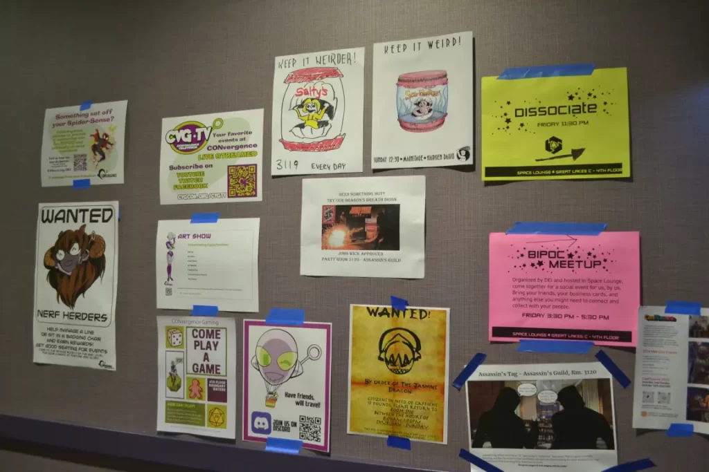 Many different posters on the wall at CONvergence 2024