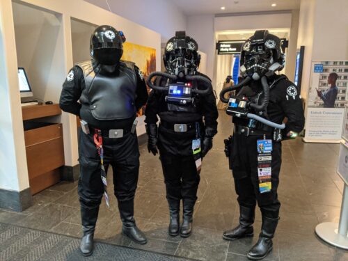 Members of the Star Wars 501st Legion dressed as rebel fighter pilots with helmets and pilot masks