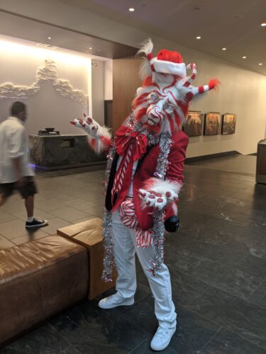 CONvergence 2021 member in a white and red striped, peppermint-themed fur suit
